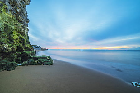 timelapse photography of beach shoreline under blue sky at daytime thumbnail