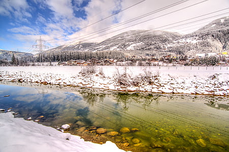 buildings near lake covered with snow during daytime thumbnail