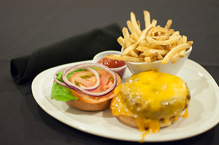 French fries in a bowl beside orange sauce thumbnail
