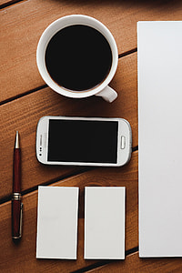 Red rowan fruit with a coffee and a white sheet of paper thumbnail