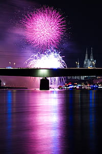 photo of fireworks display near bridge during nighttime thumbnail
