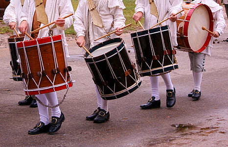 person carrying red and brown drums thumbnail