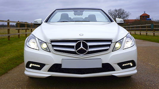 white Mercedes-Benz car parked near grass field thumbnail