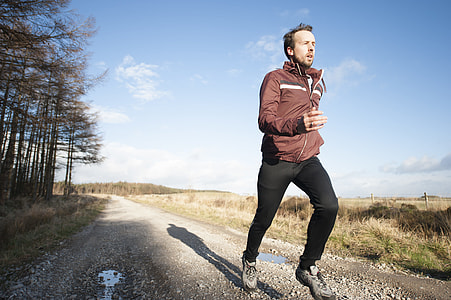 man jogging on gray road thumbnail
