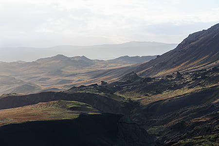 brown and black mountains under white sky during daytime thumbnail