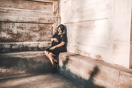 woman sitting in front of white wall thumbnail