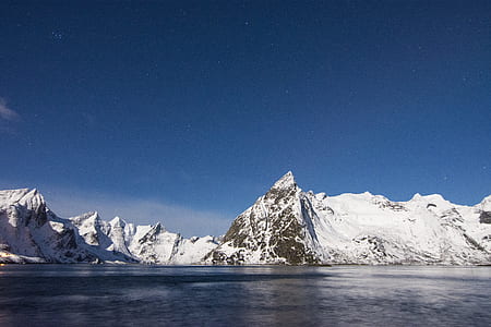 mountain covered with snow during daytime thumbnail