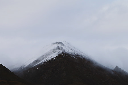 silhouette photo of mountain covered with fog thumbnail