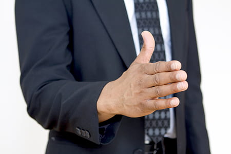 man standing wearing black suit thumbnail