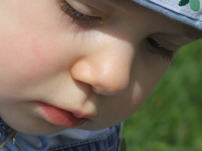 toddler's face close-up photography thumbnail