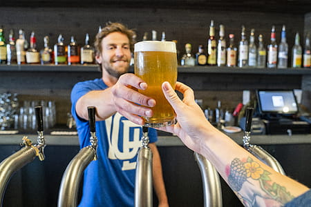 Man Handing a Person a Glass of Beer thumbnail