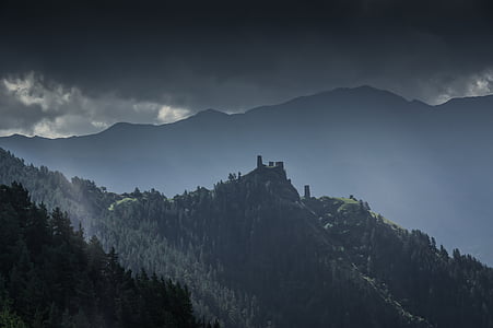 green trees near mountain during daytime thumbnail