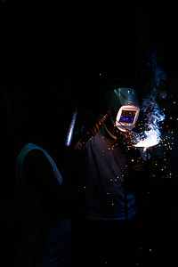 person wearing gray welding mask holding welding machine thumbnail