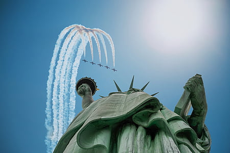Statue of Liberty in low-angle photography of five airplanes thumbnail