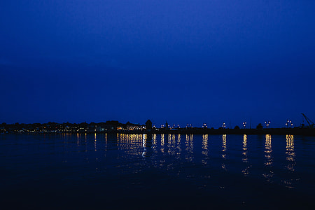 City lights reflected in the water at night thumbnail
