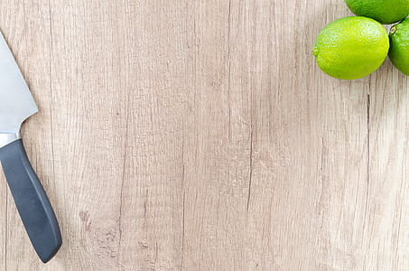 kitchen knife beside three limes thumbnail