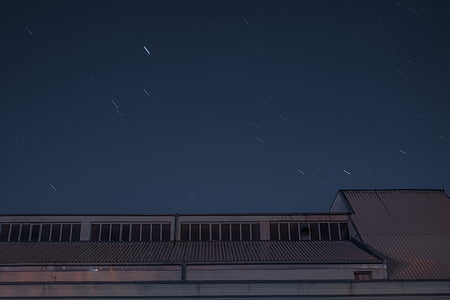 grey building under grey sky during night time thumbnail