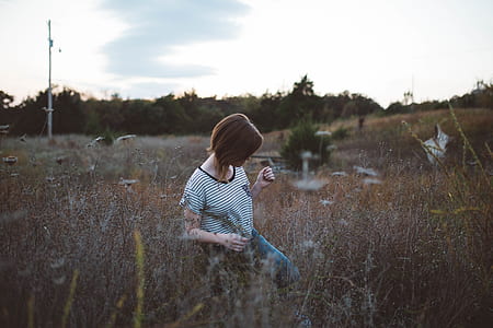 woman with short hair wandering in brown grasses thumbnail