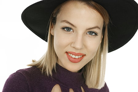 woman in black hat taking selfie thumbnail