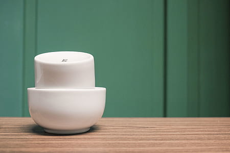 white ceramic bowl on brown wooden board thumbnail