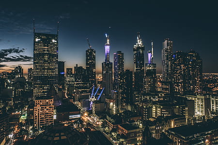high-angle photography of black high-rise commercial buildings during nighttime thumbnail