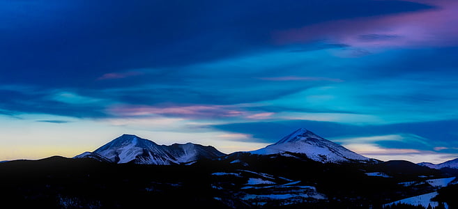 landscape photo of mountain coated with snow during golden hour thumbnail