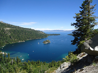 aerial view photography of lake between trees under calming sky thumbnail