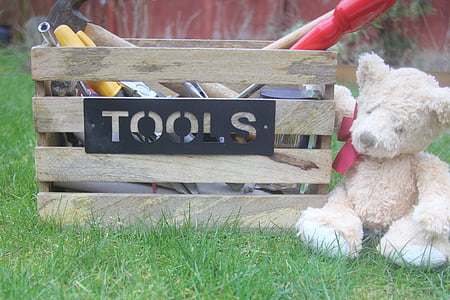 teddy bear near toolbox on grass thumbnail