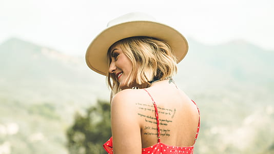 smiling woman while wearing brown hat thumbnail