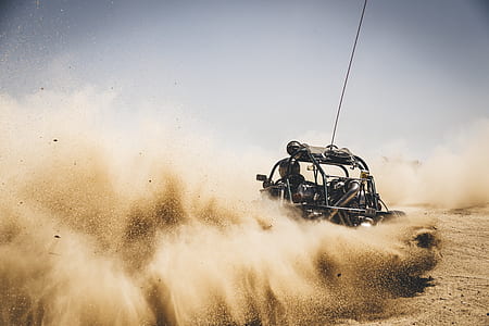 person riding a vehicle driving at the desert thumbnail