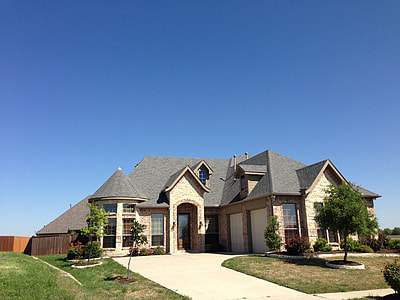 gray and white concrete house under blue and white sunny sky during daytime thumbnail