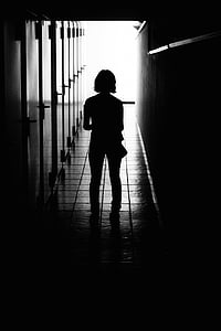 silhouette of girl standing on hallway thumbnail