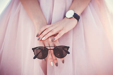 person holding black sunglasses thumbnail