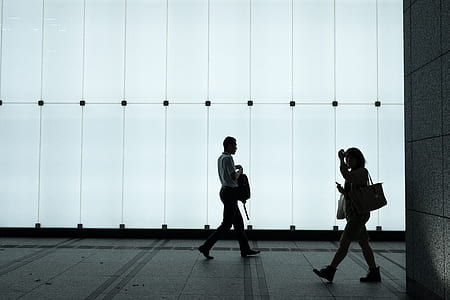 man and woman walking on road thumbnail