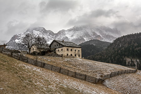 concrete 3-storey house on mountain surrounded by wooden fence thumbnail