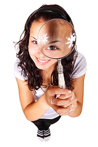 smiling woman holding white and gray magnifying glass thumbnail
