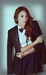 woman wearing white and black dress with bowtie thumbnail