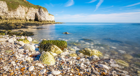landscape photography of seashore under blue sky thumbnail