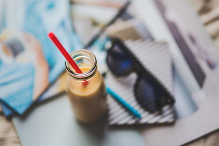 selective focus photography of liquid-filled bottle with strap thumbnail