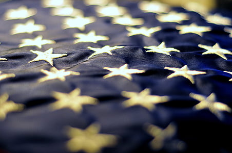 tilt shift lens photography of blue and gray star embroidered thumbnail