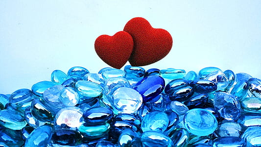 blue pebbles with two red hearts on top thumbnail