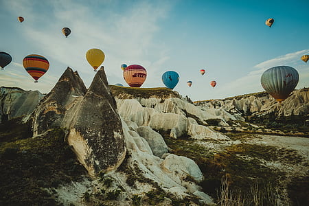 assorted-color hot air balloon under cloudy sky thumbnail