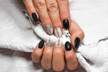 person's hand with black and white nail polish thumbnail