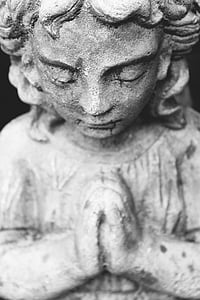 closeup photo of girl praying concrete statue thumbnail