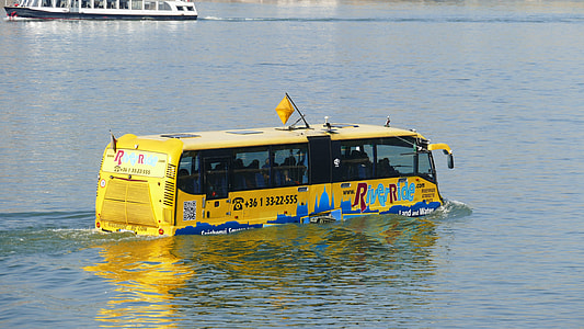 yellow tour bus in body of water thumbnail