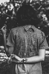 woman with cross tattoo on hand thumbnail