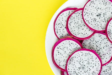 sliced dragon fruits on white plate thumbnail