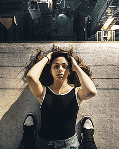 woman in black top laying on building thumbnail