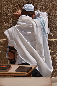 man leaning on brown concrete wall during daytime thumbnail