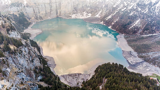 aerial photo of lake surrounded by mountain thumbnail